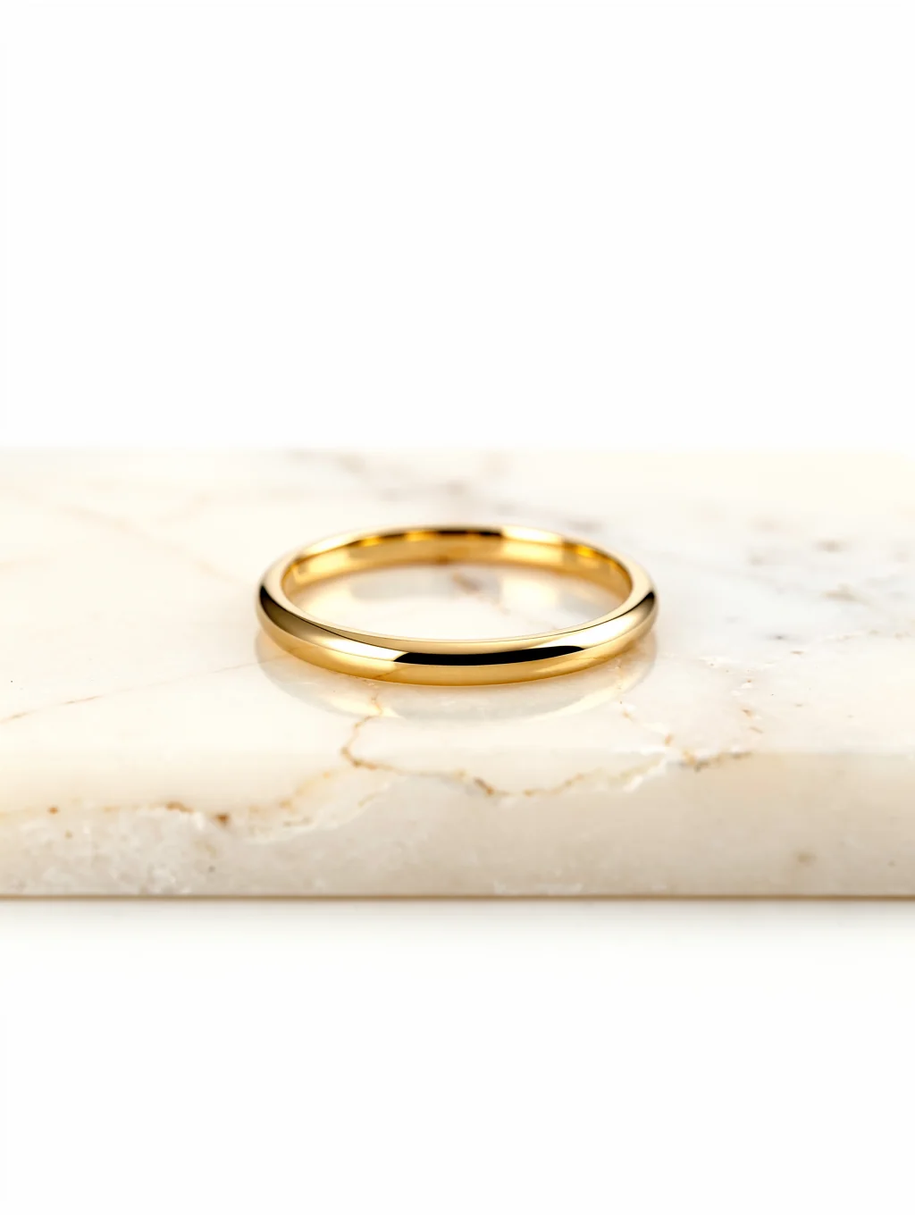 Hand-set diamond ring in 18k gold resting on a textured alabaster surface
